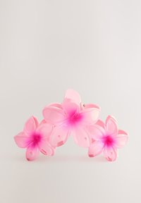 Transparent pink plastic hair clip shaped like three flowers, featuring lighter pink accents in the center and small holes for decorative detail.
