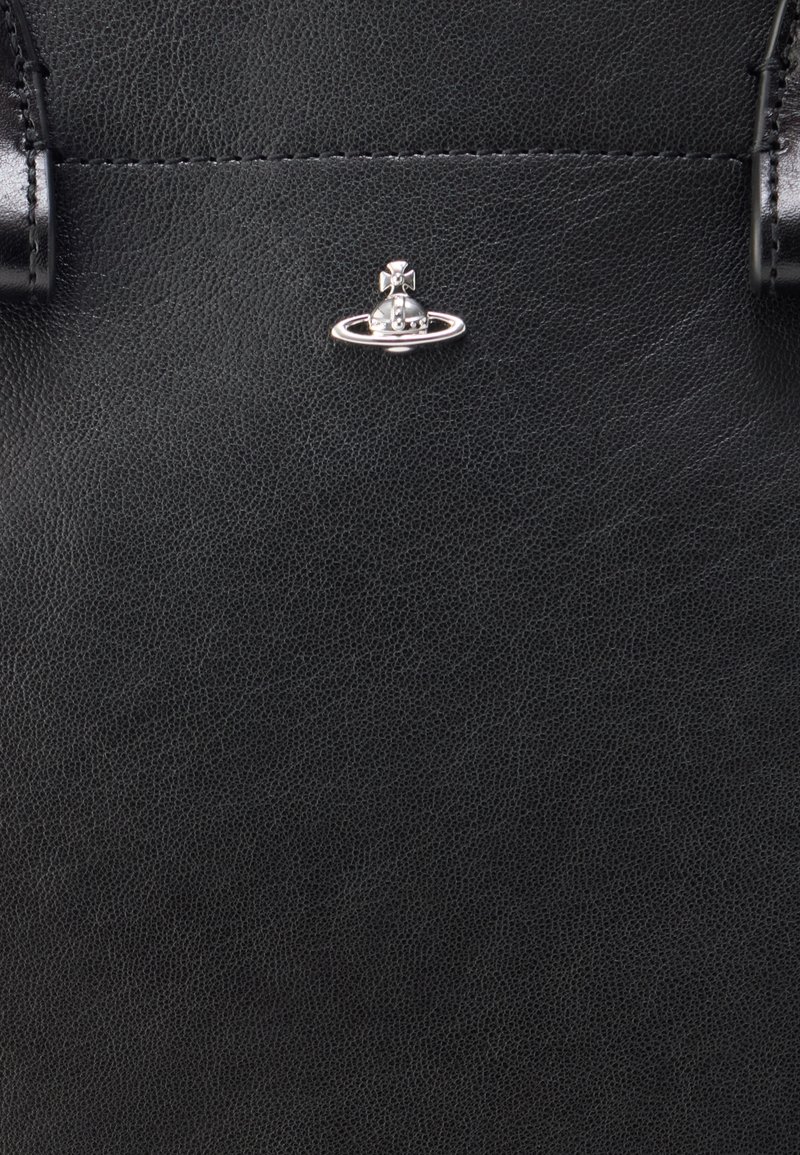 Black leather handbag featuring a textured finish, with a metallic hardware accent of a circular planet design at the center.