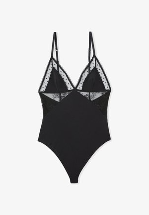 Schwarzer Bodysuit mit Spitzenakzenten, transparenten Einsätzen und Polka-Dot-Details. Verfügt über verstellbare Träger und eine figurbetonte Silhouette.