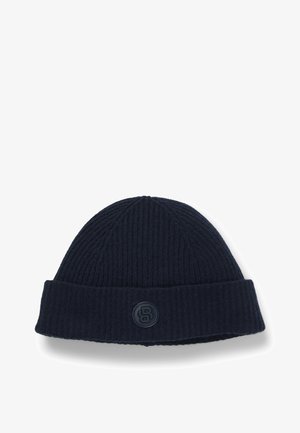 Knitted navy beanie with a ribbed texture, featuring a rolled cuff and a circular logo patch with the letter "B."