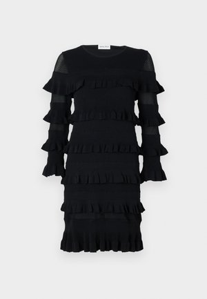 Mustmust, millede rufflite, pikad varrukad võrkkattega ja ribalik tekstuur. Ümar kaelus, keskmise pikkusega stiil.