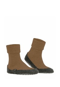 Brązowe wełniane skarpetki z zagiętym mankietem i szarym filcowym spodem, zdobione białymi kropkami wzdłuż krawędzi, co zapewnia przyczepność i kontrast tekstur.