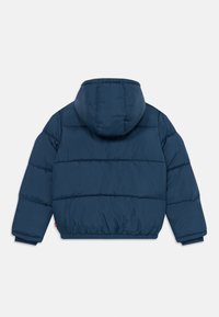 Tamno plava podstavljena jakna s elastičnim rubom i manžetama, koja ima veliku kapuljaču i horizontalno quilted leđa.