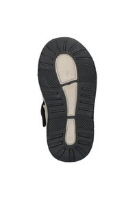 Zwarte rubberen zool met een gestructureerde grip, met een witte middenzool en gebogen uitsparingen; klittenbandsluiting voor gemakkelijk aan- en uittrekken.