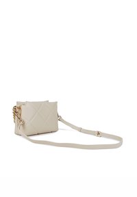 Beige quilted crossbody bag made from smooth leather. Features a chain accent and a detachable strap for versatile carrying options.