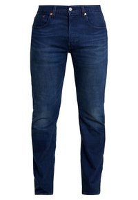 Joggers de mezclilla azul oscuro con un corte recto clásico. Presentan remaches de cobre, cinco bolsillos y un cierre frontal estándar con botón y cremallera.