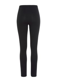 Leggings noirs avec une texture lisse, un design ajusté et une taille élastique, présentant une coupe longueur entière. Pas de logos ou motifs visibles.