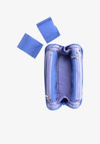 Estuche para lápices de color púrpura claro con cremallera, abierto para mostrar dos compartimentos internos con dos divisores removibles de tela azul encima.