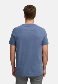 T-shirt a maniche corte in cotone blu chiaro, con colletto a girocollo e texture liscia, con orlo dritto e senza grafiche visibili.