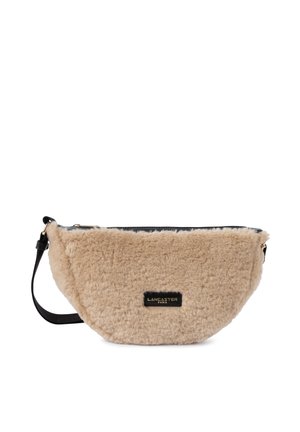 Beige fuzzy handbag with a black leather top and strap. Features rounded rectangular shape and gold hardware with embossed logo.