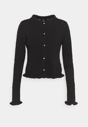 Zwarte gebreide cardigan met een klassieke kraag, knoopsluiting met gouden accenten, een gestructureerd patroon en gerafelde zoom en manchetten.