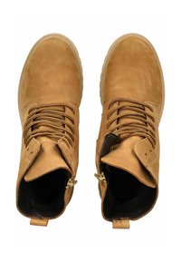 Brown leather ankle boots with rounded toes, textured surface, and gold-tone zippers. Features brown laces and padded collars for support.