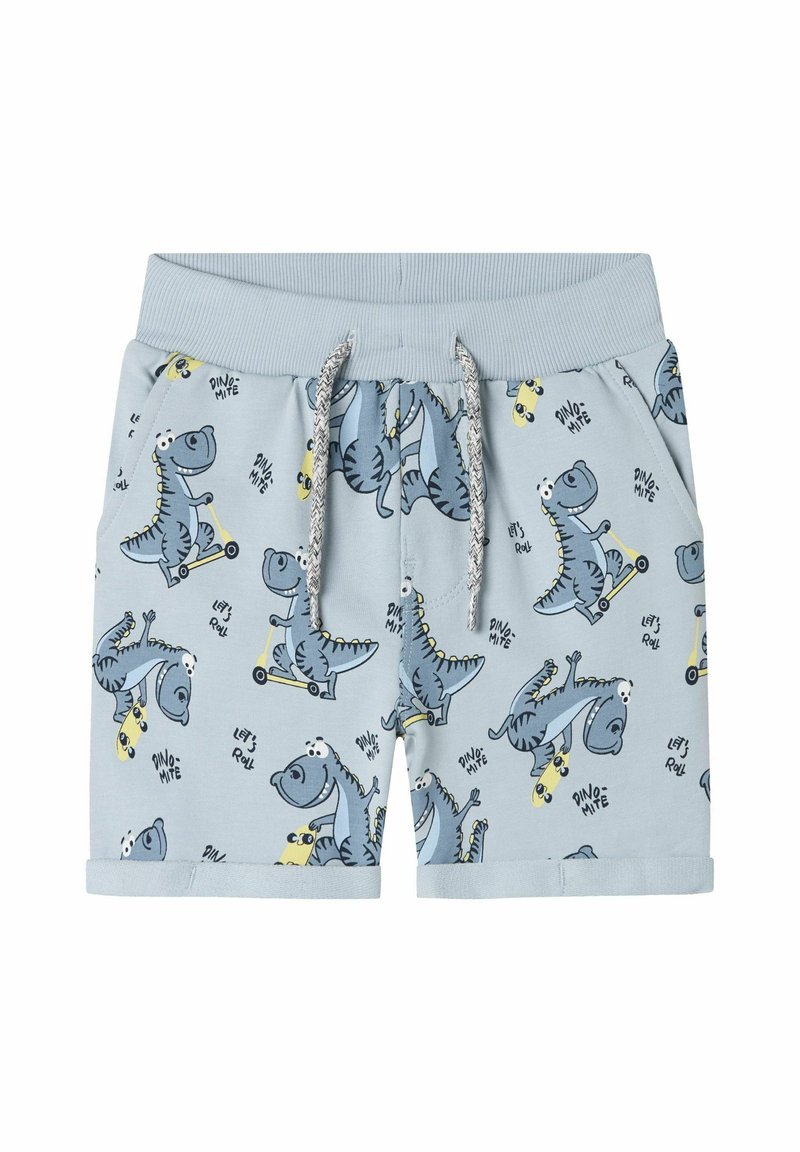 Ljusblå barnshorts i bomull, med dinosaurtryck, elastisk midja med snörning och fållade benslut.