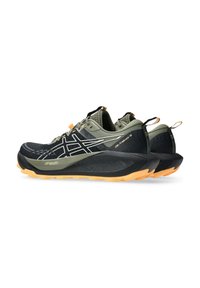 Schwarze und olivgrüne Trailschuhe mit einer strukturierten Oberfläche, weißen Akzenten und orangen Details. Dicke schwarze Sohle mit einer orangen Außensohle.