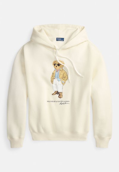 Sweatshirt com capuz creme, com um gráfico de um urso de óculos escuros e casaco, com bainha e punhos canelados, e cordão no capuz.