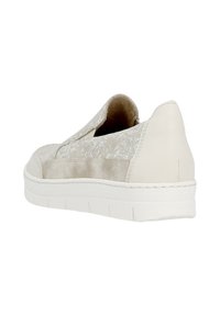 Chaussure beige à enfiler avec un avant en dentelle texturée et un dos lisse, dotée d'une semelle blanche et de coutures subtiles le long du bord.
