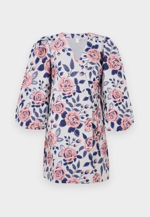 Floral wrap dress featuring a light gray background, pink roses, dark blue leaves, and three-quarter puff sleeves. Ties at the waist.