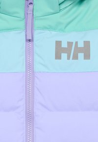 Nahaufnahme eines Jackenreißverschlusses mit Farbkombinationen in Minzgrün, Hellblau und Lavendel, mit einem reflektierenden "HH"-Logo auf der Brust.