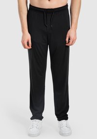 Schwarze sportliche Jogginghosen mit elastischem Bund, Kordelzug und lockerer Passform. Hergestellt aus glattem Material und mit seitlichen Taschen.
