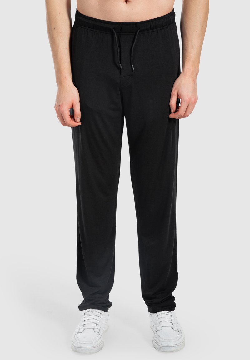 Schwarze sportliche Jogginghosen mit elastischem Bund, Kordelzug und lockerer Passform. Hergestellt aus glattem Material und mit seitlichen Taschen.