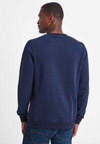 Navy blue sweatshirt with long sleeves, ribbed cuffs, and hem, made from soft material, featuring a simple crew neckline and no visible graphics.