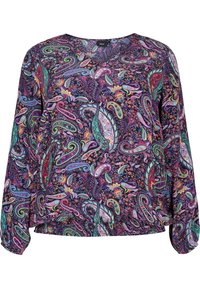 Blusa a maniche lunghe di un viola scuro con un vivace motivo paisley in tonalità di verde, rosa e giallo. Vestibilità ampia con orlo elastico.
