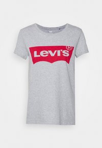 Šedé bavlněné tričko s krátkými rukávy, které má výrazné červené logo Levi's v bílé barvě umístěné na křivkovém pozadí.