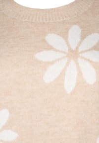 Beige Strickpullover mit weißen Gänseblümchen-Mustern. Das Design umfasst einen gerippten Kragen und eine weiche Textur, ideal für legere Freizeitkleidung.