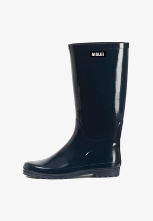 Botte de pluie en caoutchouc noir brillant avec semelle crantée et logo "Aigle 1853" près du haut, vue de côté sur fond blanc.