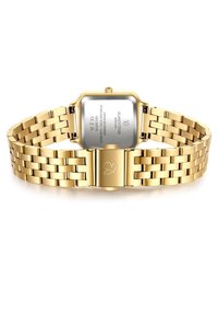 Kuldsinine roostevabast terasest kell, millel on ruudukujuline korpus, metallist link-rakendus ja klamber, millel on lehekujuline disain. Graveeritud tagaküljel olevad detailid on nähtavad.