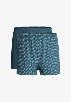 Zwei Paar Badeshorts mit elastischen Taillenbändern. Das eine ist einfarbig dunkles Petrol; das andere zeigt ein hellblaues abstraktes Muster auf petrolfarbenem Hintergrund.