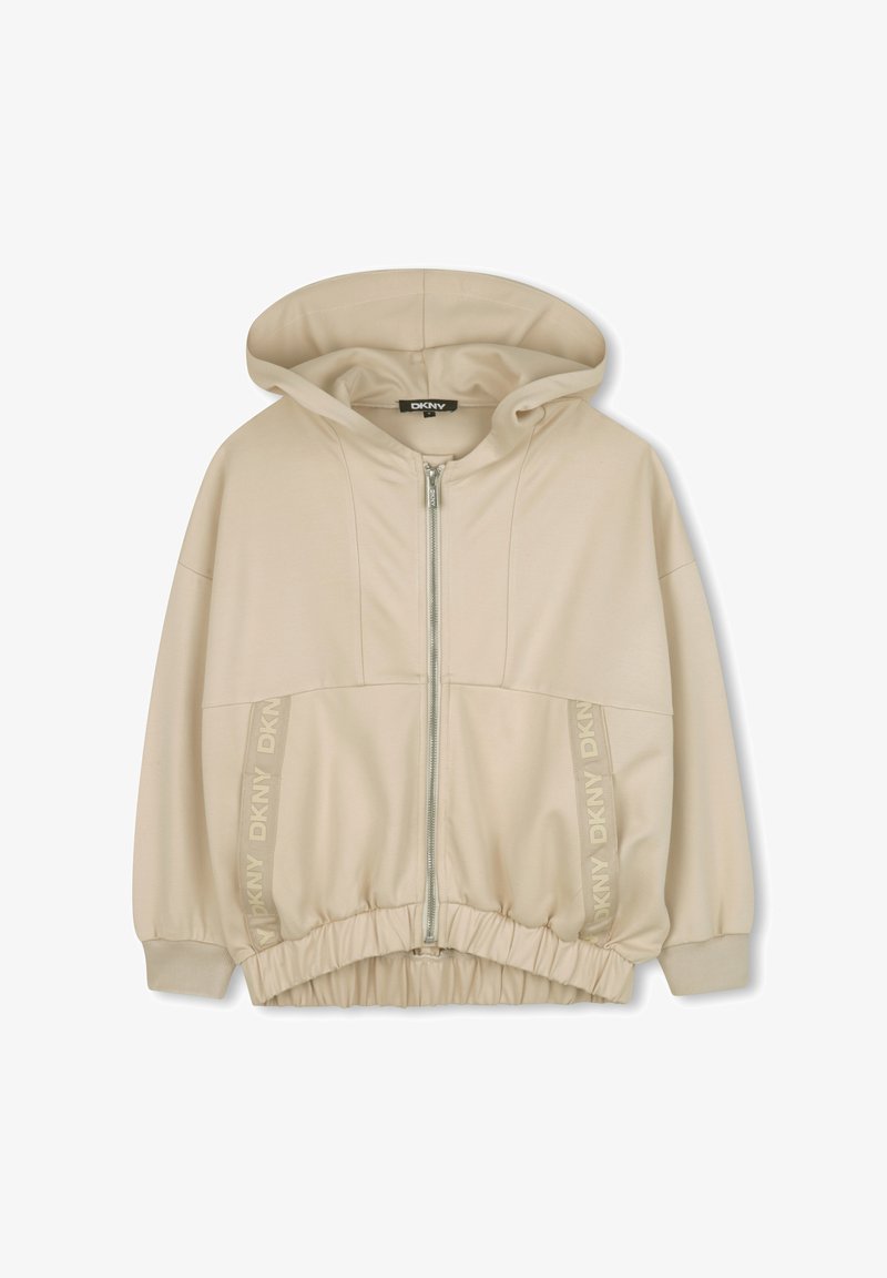 Sweat à capuche zippé beige avec une capuche, une taille élastique et des accents de logo imprimés sur le côté. Tissu doux avec une texture lisse.