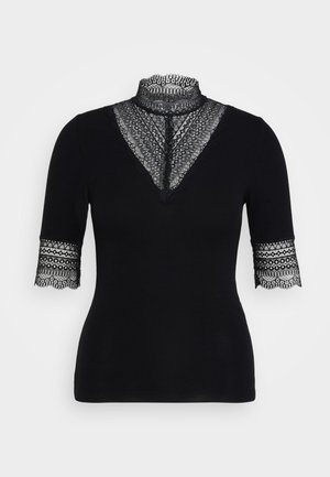 Top negro de canalé con un alto cuello de encaje y mangas cortas con detalles de encaje en los puños. Textura suave con un diseño intrincado.