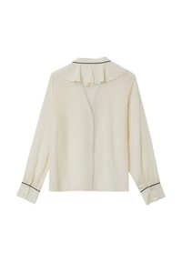 Blusa color crema con colletto volant, maniche lunghe e dettagli in piping neri. Presenta polsini con bottoni e una vestibilità rilassata.