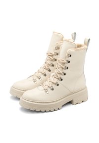 Kremowe skórzane botki za kostkę z sztucznym futerkiem, metalowymi oczkami i pasującymi sznurówkami. Gruba beżowa podeszwa zapewnia wytrzymałą przyczepność.