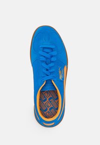 Bright blue Puma Palermo sneaker with orange trim, laces, and branded insole, shown from top view against a white background.