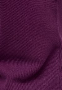 Knitted fabric in a deep purple color, showcasing a textured pattern with fine, diagonal ridges and subtle sheen.