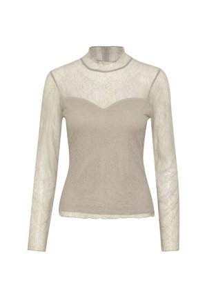 Beige long-sleeve top with sheer lace overlay, mock neck, and fitted bodice. Textured floral pattern with scalloped hemline.