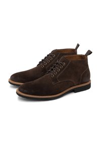 Stivaletti in suede marrone, con punta rotonda, design lacciato, cuciture a contrasto color tan e suola in gomma. Presentano fasce di tira sul retro.