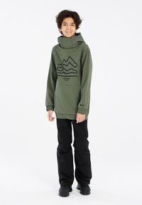 Groene hoodie jas met zwart bergafbeelding, elastische manchetten, losse pasvorm. Draag over zwarte broek, geschikt voor buitenactiviteiten.