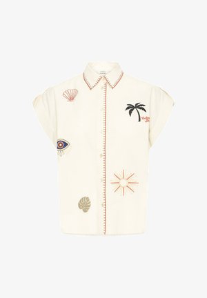 Valkoinen, lyhythihainen nappipaita, jossa on kirjailtuja palmupuita, aurinkoa, simpukkaa, silmää ja lehtiä. Paidassa on punainen reunus kauluksen ja napituslinjan ympärillä.