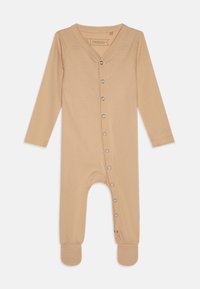 Bodysuit beige à manches longues en coton doux, avec un col en V, fermeture par boutons-pression à l'avant et design avec pieds.