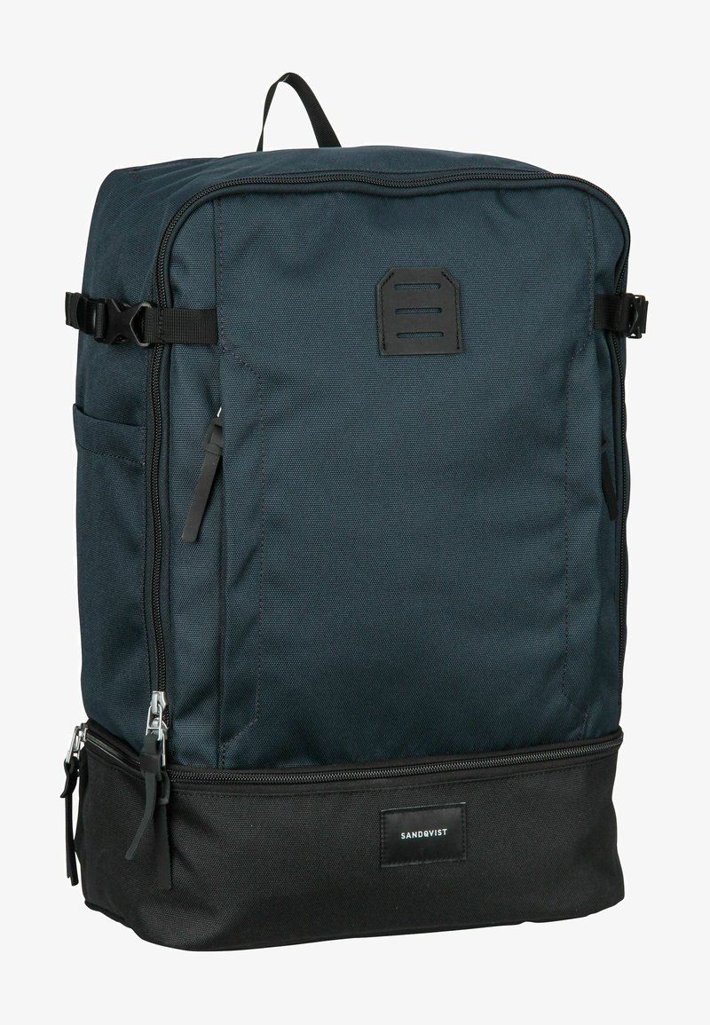 Dark blue backpack with a rectangular shape, made of durable fabric, featuring a top handle, adjustable straps, and black accents.
