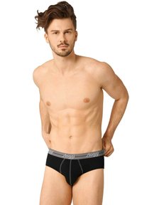 Culotte en coton noir avec une ceinture élastique grise portant le logo "sloggi", détail de couture sur le devant et un design ajusté.