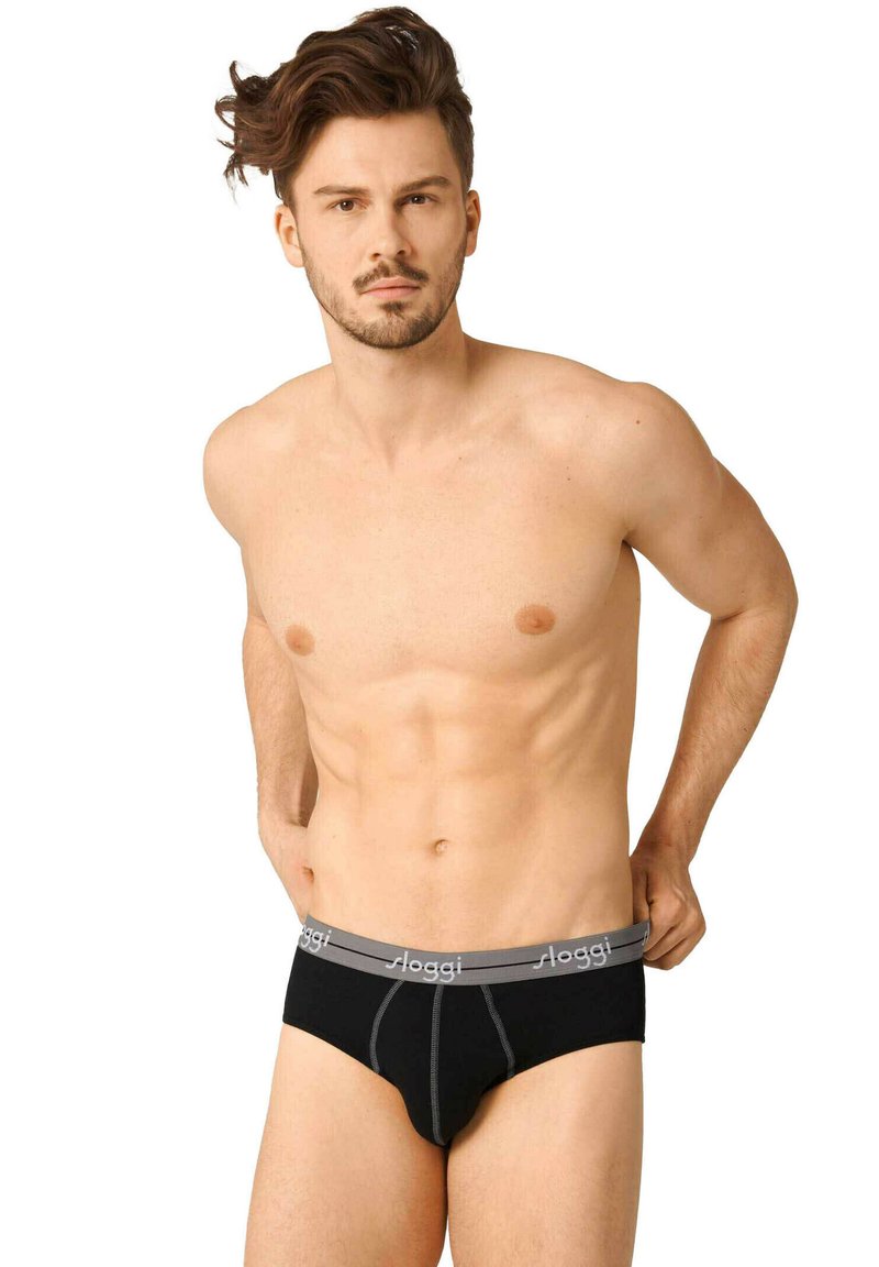 Culotte en coton noir avec une ceinture élastique grise portant le logo "sloggi", détail de couture sur le devant et un design ajusté.