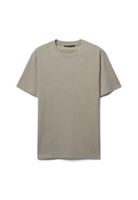 T-shirt corto a maniche corte color beige chiaro realizzato in cotone morbido. Presenta un colletto rotondo e un design semplice e privo di decorazioni. Vestibilità classica.