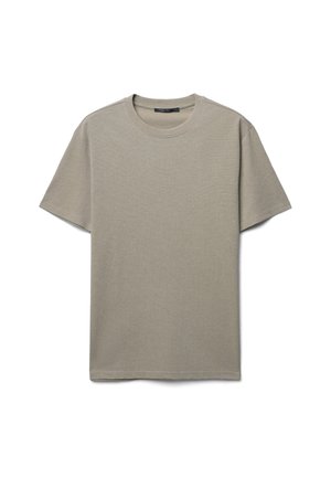 T-shirt beige clair à manches courtes en coton doux. Avec un col rond et un design simple et épuré. Coupe classique.