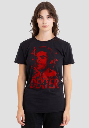 Black cotton t-shirt featuring a red graphic print of a face and the text "DEXTER" in bold, distressed lettering, splattered effect design.