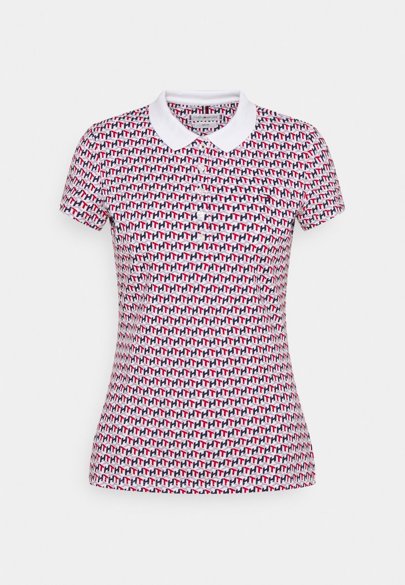 Short-sleeved polo shirt in white with a repeating geometric pattern in red and navy. Features a classic collar and fitted silhouette.