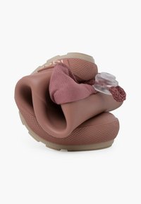 Sandale en caoutchouc mauve avec une sangle texturée et des accents élastiques. Dispose d'une semelle rembourrée et d'un design flexible et ouvert à l'avant.